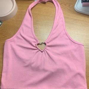 Pink shirt with heart in the middle . Looks good with low rise jeans.